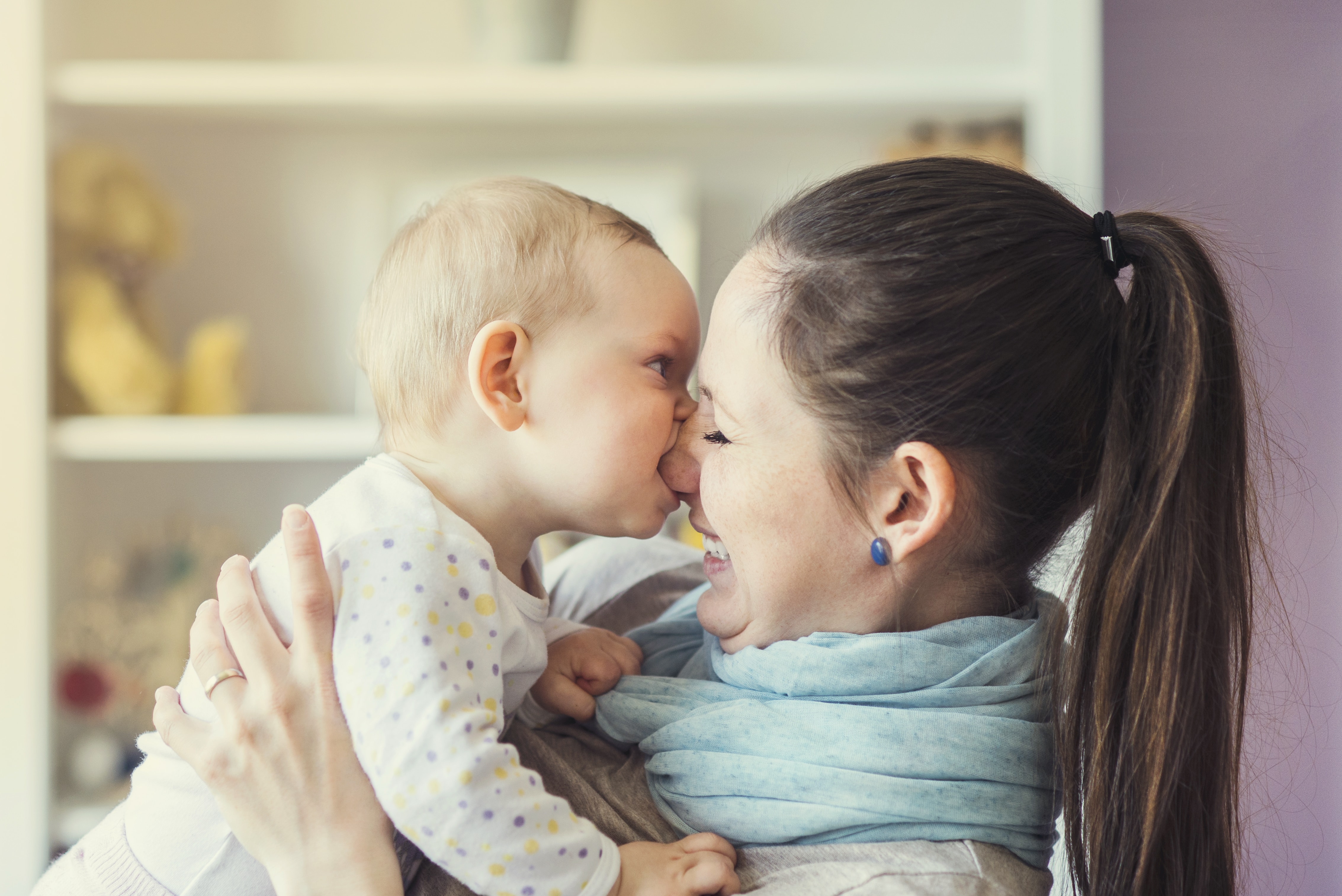 toddler biting her mom